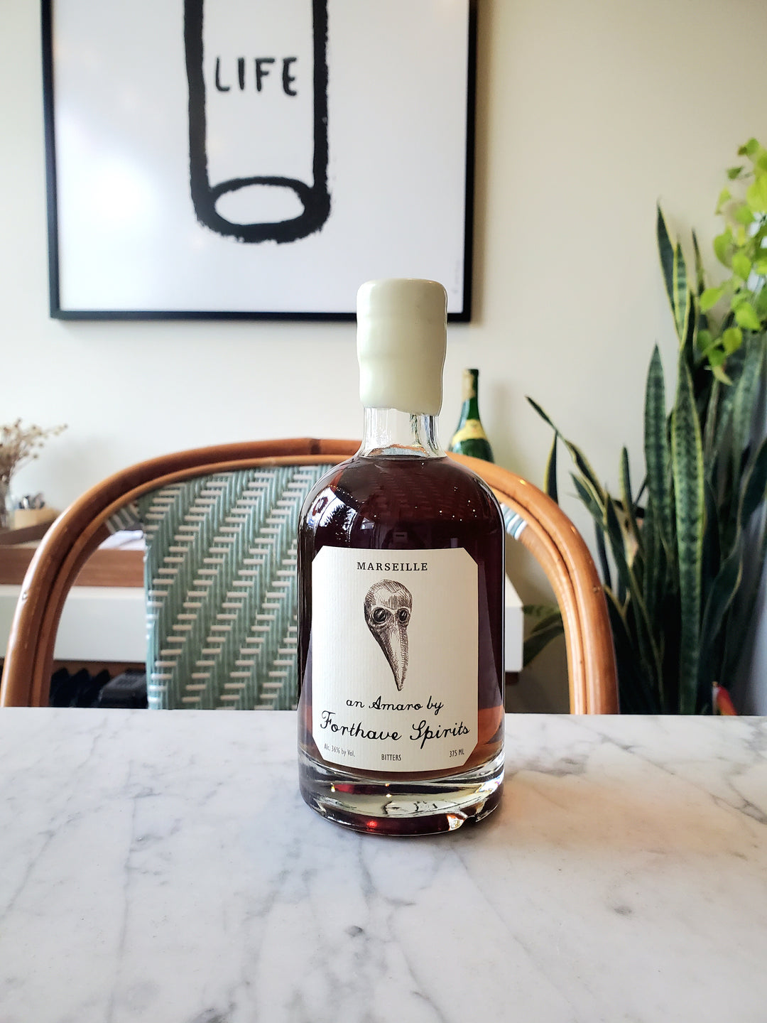 Bottle of Forthave amaro on a marble surface